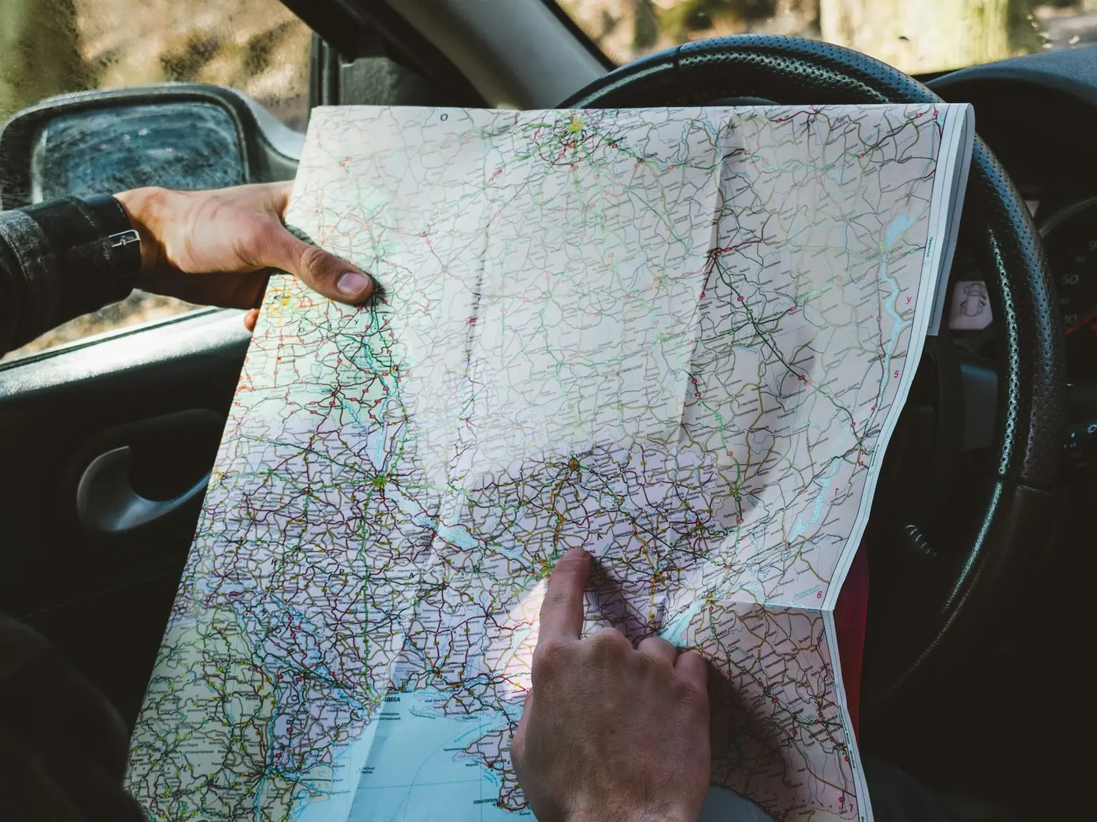 person holding map in vehicle\